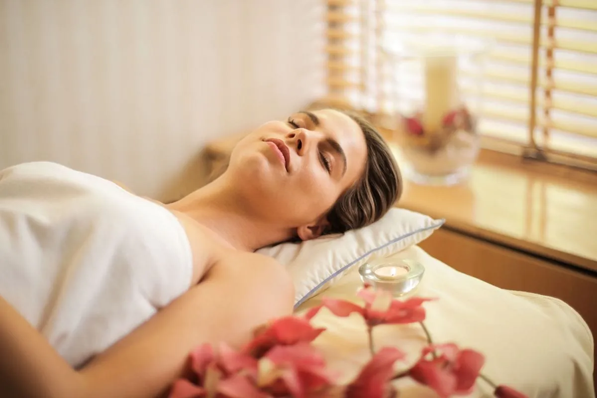 Client relaxing on a treatment couch during a massage